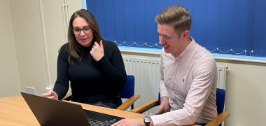 Natalie & Tom at a desk